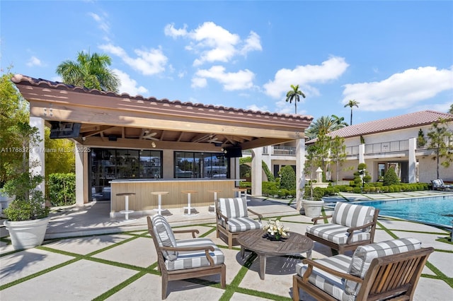 600 Isle Of Palms Dr, Fort Lauderdale, FL 33301 - view of patio / terrace featuring a community pool, an outdoor living space, and outdoor dry bar