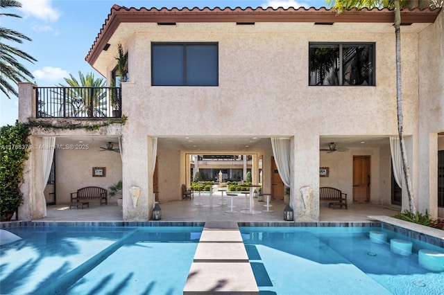 600 Isle Of Palms Dr, Fort Lauderdale, FL 33301 - rear view of property with a patio area, stucco siding, a balcony, and an outdoor pool