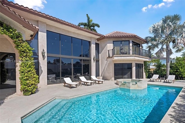 600 Isle Of Palms Dr, Fort Lauderdale, FL 33301 - rear view of house with a tiled roof, a pool with connected hot tub, a patio area, a balcony, and stucco siding