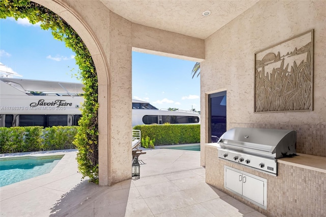 600 Isle Of Palms Dr, Fort Lauderdale, FL 33301 - view of patio / terrace with an outdoor pool, exterior kitchen, and a grill