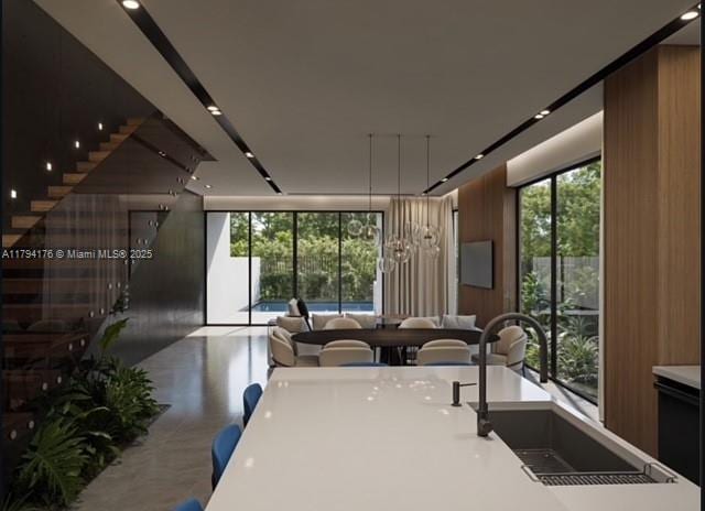 kitchen with a sink, plenty of natural light, modern cabinets, and open floor plan