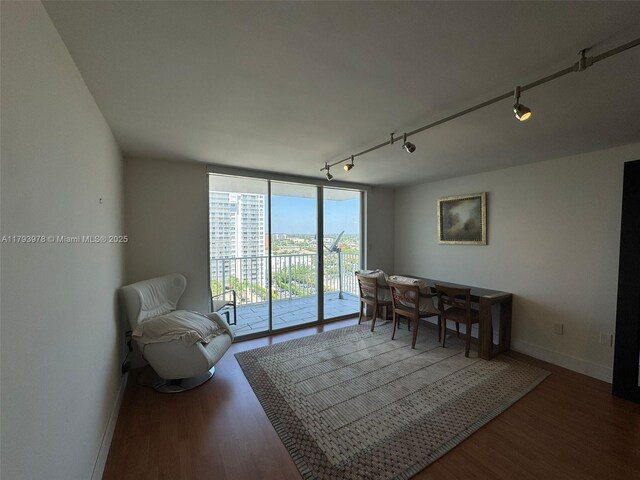 2851 NE 183rd St Unit 1408E, Aventura, FL 33160 - dining space featuring baseboards, floor to ceiling windows, track lighting, and wood finished floors