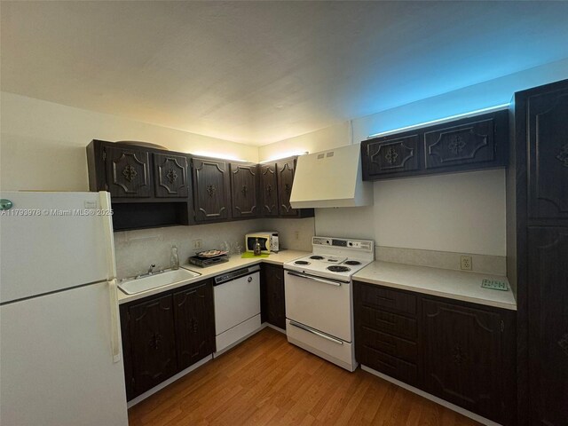 2851 NE 183rd St Unit 1408E, Aventura, FL 33160 - kitchen with white appliances, light wood-type flooring, light countertops, ventilation hood, and a sink