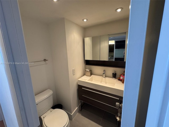 half bath with tile patterned flooring, vanity, baseboards, toilet, and recessed lighting