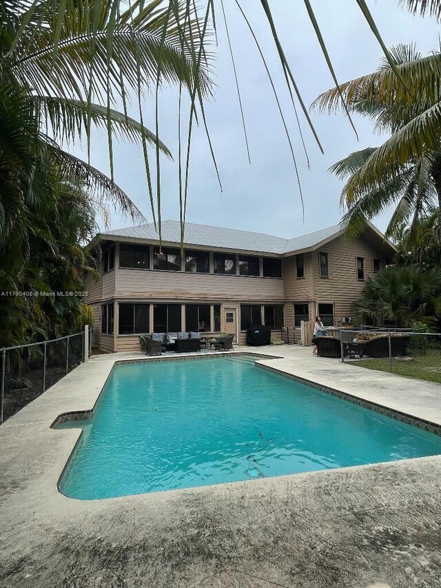 10737 SE Seaspray Ct, Hobe Sound, FL 33455 - swimming pool featuring a patio and outdoor lounge area