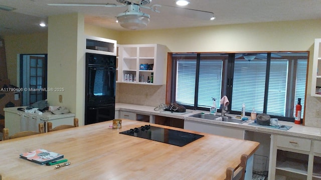10737 SE Seaspray Ct, Hobe Sound, FL 33455 - kitchen with black appliances, white cabinets, and recessed lighting