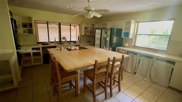 10737 SE Seaspray Ct, Hobe Sound, FL 33455 - kitchen featuring open shelves, white cabinets, light tile patterned floors, ceiling fan, and freestanding refrigerator