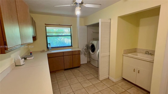 10737 SE Seaspray Ct, Hobe Sound, FL 33455 - washroom featuring light tile patterned floors, ceiling fan, and washing machine and clothes dryer
