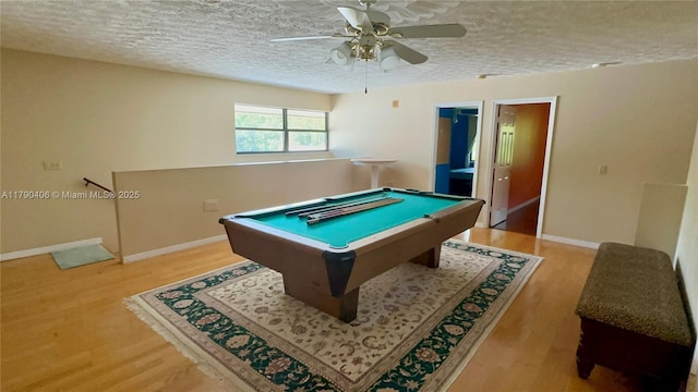 10737 SE Seaspray Ct, Hobe Sound, FL 33455 - rec room featuring a textured ceiling, light wood-style flooring, pool table, and a ceiling fan