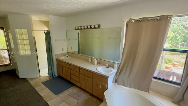 10737 SE Seaspray Ct, Hobe Sound, FL 33455 - bathroom featuring a garden tub, double vanity, a shower with shower curtain, a textured ceiling, and tile patterned flooring