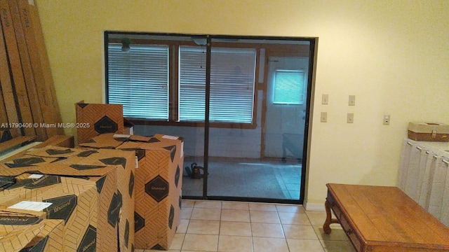 10737 SE Seaspray Ct, Hobe Sound, FL 33455 - bedroom featuring light tile patterned floors