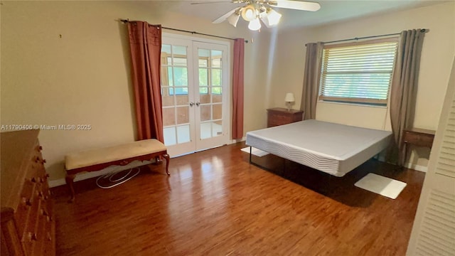 10737 SE Seaspray Ct, Hobe Sound, FL 33455 - bedroom featuring french doors, wood finished floors, multiple windows, and ceiling fan