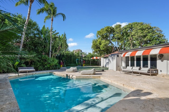 outdoor pool with a patio area