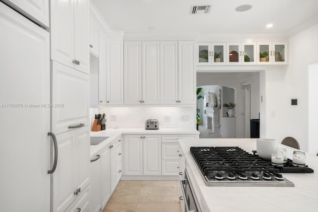 kitchen with light countertops, white cabinets, and stainless steel gas cooktop