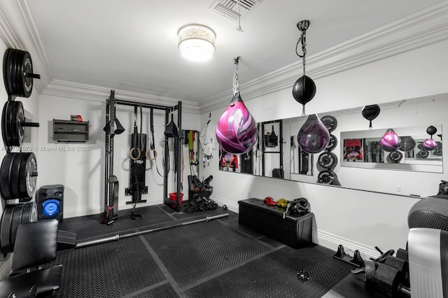 workout area featuring crown molding, baseboards, and visible vents