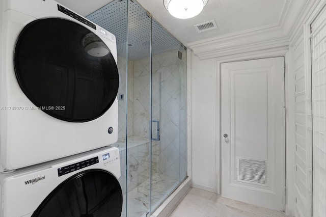 bathroom with visible vents, stacked washer and dryer, a marble finish shower, and ornamental molding