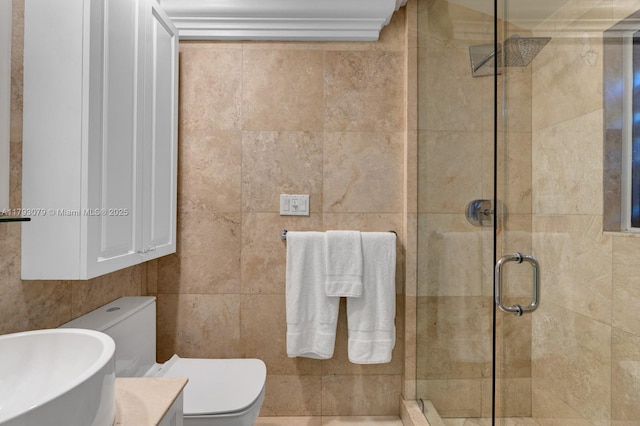 full bathroom with toilet, tile walls, and a shower stall
