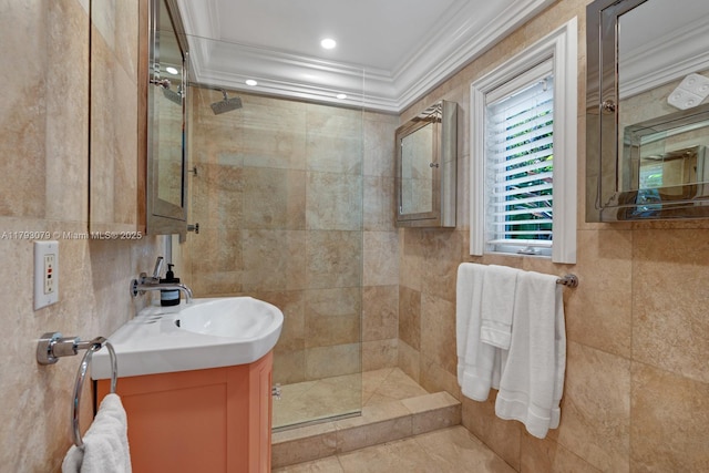 full bath featuring vanity, ornamental molding, walk in shower, and tile walls