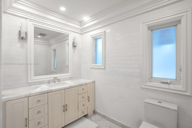 bathroom with crown molding, tile walls, visible vents, and vanity