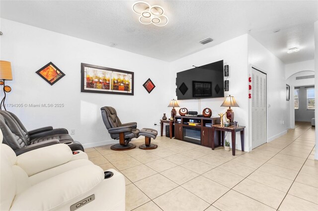 10012 NW 7th St Unit 107, Miami, FL 33172 - living room with light tile patterned floors, a textured ceiling, and baseboards