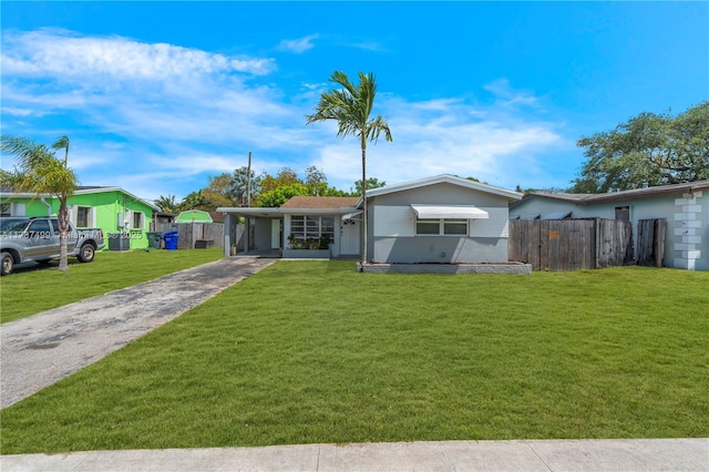 6501 Scott St, Hollywood, FL 33024 - view of front of house featuring fence, a carport, driveway, and a front lawn