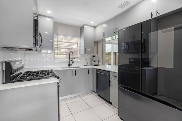 6501 Scott St, Hollywood, FL 33024 - kitchen featuring a sink, light countertops, black microwave, and dishwashing machine