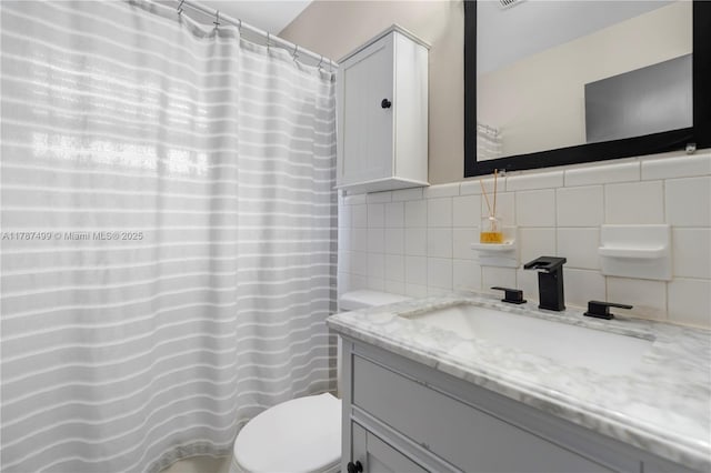 6501 Scott St, Hollywood, FL 33024 - bathroom featuring tile walls, backsplash, vanity, and toilet