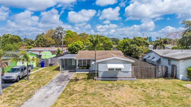 6501 Scott St, Hollywood, FL 33024 - bungalow-style house with an attached carport, aphalt driveway, fence, and a front yard