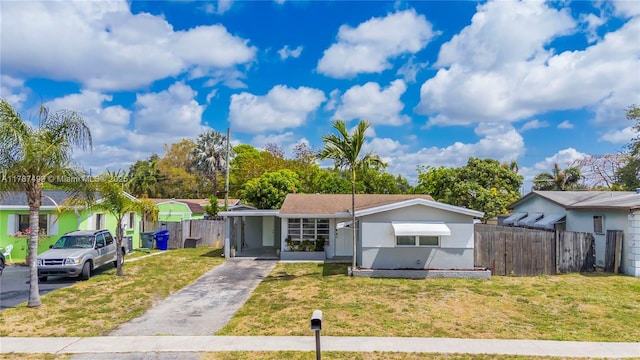 6501 Scott St, Hollywood, FL 33024 - view of front of house featuring fence, an attached carport, a front yard, and aphalt driveway