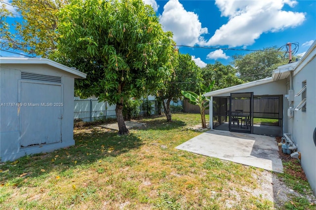 6501 Scott St, Hollywood, FL 33024 - view of yard with an outdoor structure, a sunroom, a shed, a fenced backyard, and a patio