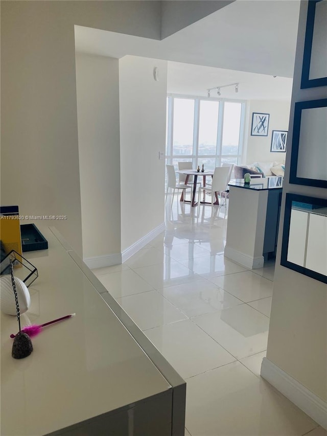 1871 NW S River Dr Unit 903, Miami, FL 33125 - corridor featuring light tile patterned floors, baseboards, and rail lighting