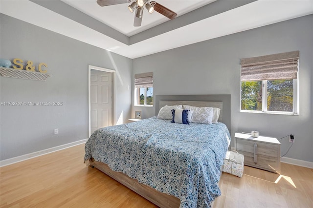 22221 SW 87th Pl, Cutler Bay, FL 33190 - bedroom with baseboards, a ceiling fan, wood finished floors, and a raised ceiling