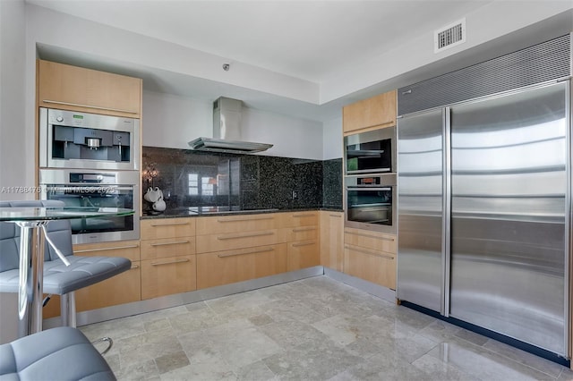101 S Fort Lauderdale Beach Blvd Unit 308, Fort Lauderdale, FL 33316 - kitchen with stainless steel appliances, wall chimney exhaust hood, and light brown cabinets