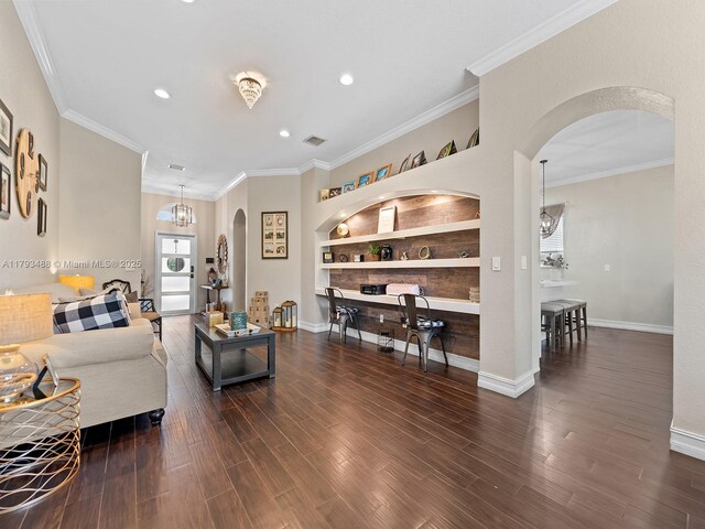 973 NE 36th Ave, Homestead, FL 33033 - living room featuring arched walkways, built in shelves, recessed lighting, baseboards, and wood finished floors