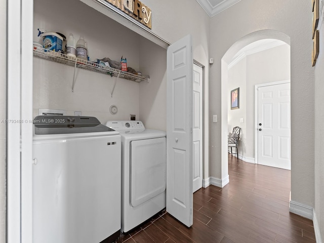 973 NE 36th Ave, Homestead, FL 33033 - washroom featuring crown molding, laundry area, arched walkways, dark wood-style floors, and washer and clothes dryer