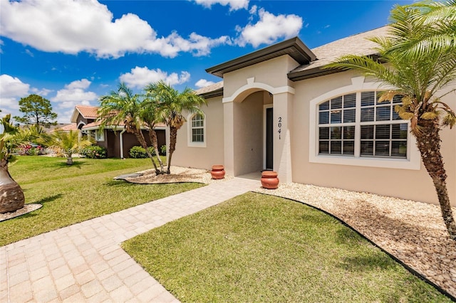 2041 SW Imperial St, Port St Lucie, FL 34987 - mediterranean / spanish-style house with stucco siding and a front lawn