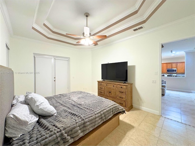 bedroom featuring crown molding, visible vents, baseboards, a raised ceiling, and a ceiling fan