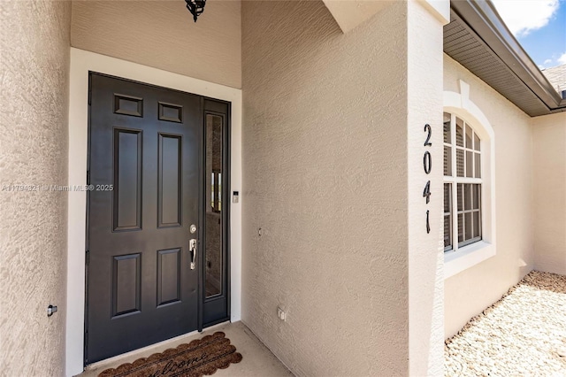 2041 SW Imperial St, Port St Lucie, FL 34987 - view of exterior entry featuring stucco siding