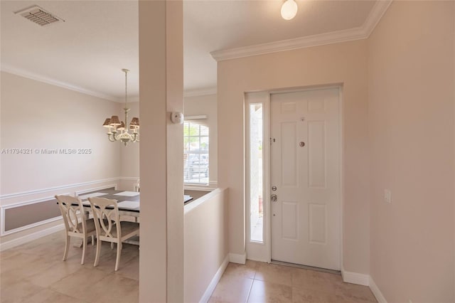 2041 SW Imperial St, Port St Lucie, FL 34987 - foyer entrance featuring ornamental molding, a chandelier, baseboards, and light tile patterned floors