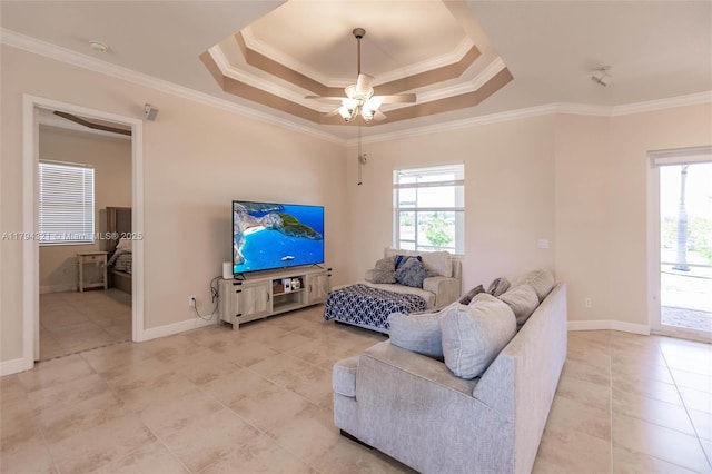2041 SW Imperial St, Port St Lucie, FL 34987 - living room featuring light tile patterned floors, ceiling fan, crown molding, a tray ceiling, and baseboards