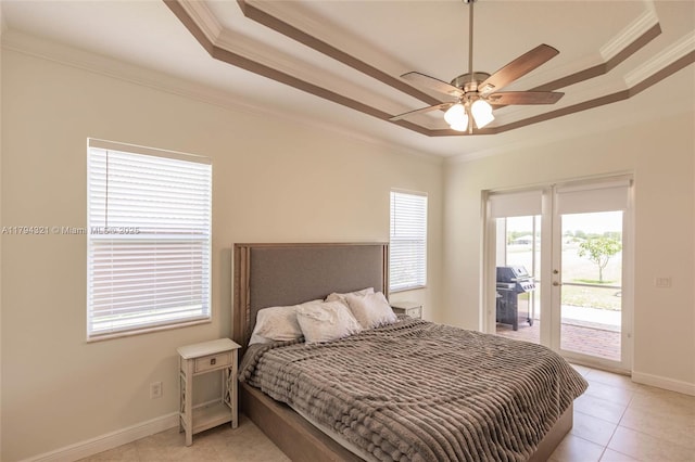 bedroom featuring crown molding, a tray ceiling, light tile patterned flooring, and access to exterior