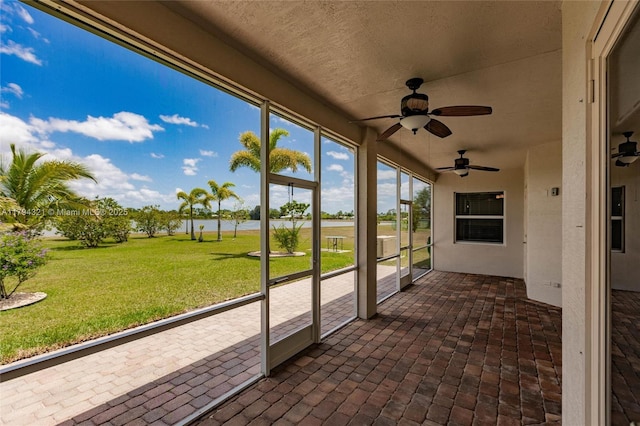 2041 SW Imperial St, Port St Lucie, FL 34987 - unfurnished sunroom featuring a ceiling fan and a water view