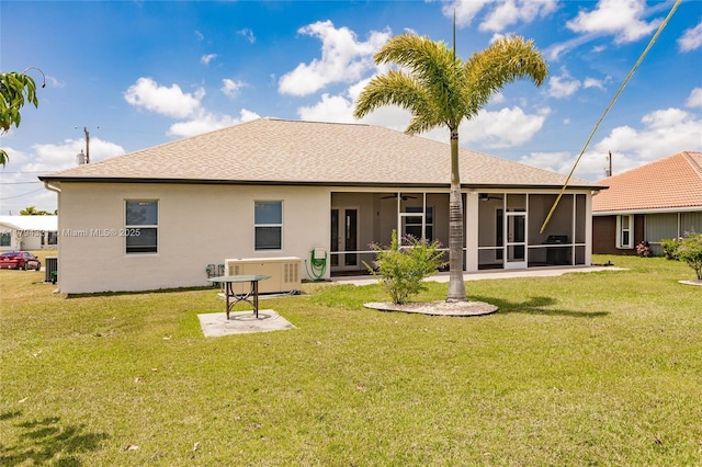 2041 SW Imperial St, Port St Lucie, FL 34987 - rear view of property featuring a ceiling fan, a sunroom, a yard, and roof with shingles