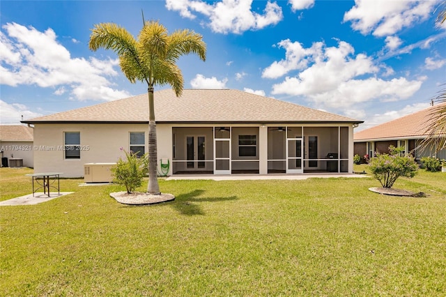 2041 SW Imperial St, Port St Lucie, FL 34987 - back of property featuring a sunroom, ceiling fan, a yard, stucco siding, and central AC unit