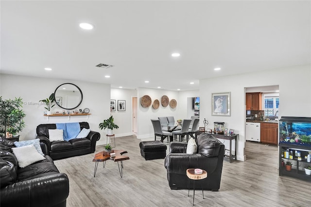living room featuring recessed lighting, visible vents, and light wood finished floors