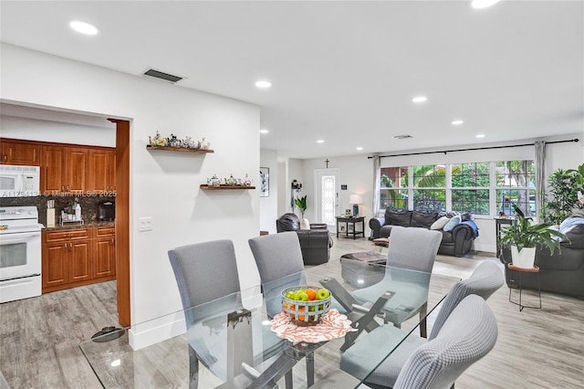dining area featuring recessed lighting, visible vents, and light wood-style flooring
