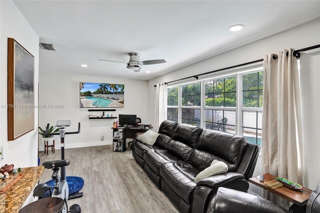 bedroom with baseboards, ceiling fan, and wood finished floors