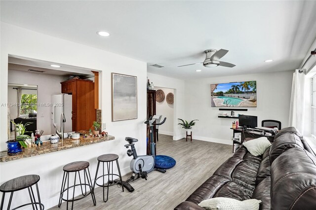 bedroom featuring visible vents, a closet, wood finished floors, baseboards, and ceiling fan