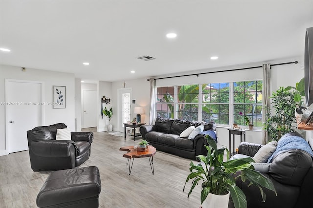 living room featuring visible vents, recessed lighting, and light wood-type flooring