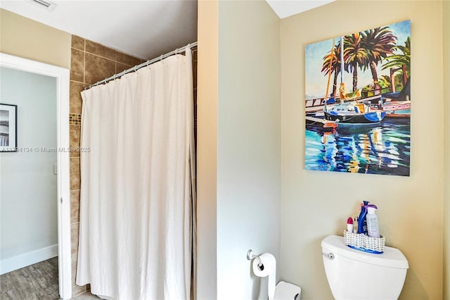 11240 Sheridan St, Pembroke Pines, FL 33026 - bathroom with toilet, curtained shower, and wood finished floors